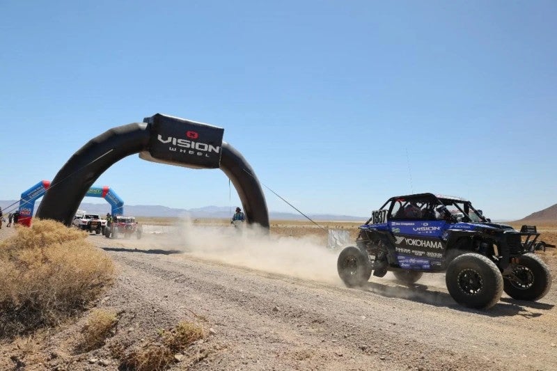 Mia Chapman vehicle passing under inflatable arch in race