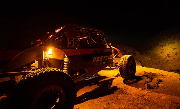 Off-road vehicle with amber Rigid lights in desert at night