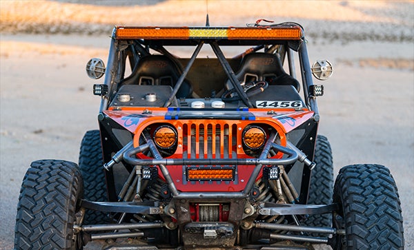 Front view of off-road vehicle equipped with Rigid lights in desert