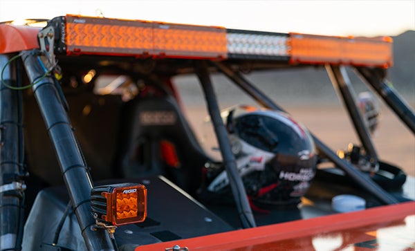 Orange Rigid light bar and light pod on vehicle